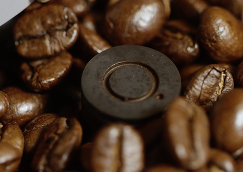 Coffee Beans in a coffee grinder for close details